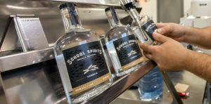 Student picks up jug of small batch vodka